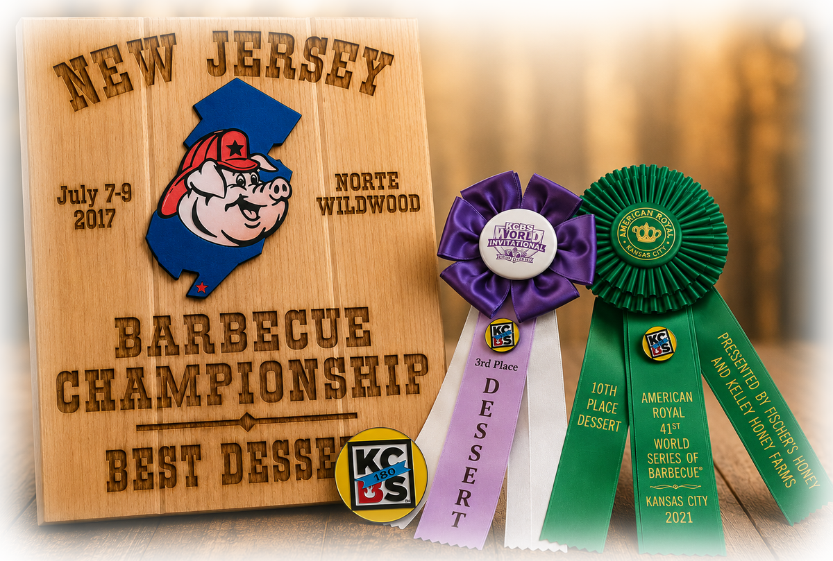 A Best Dessert plaque from the New Jersey Barbecue Championship alongside dessert ribbons from the KCBS World Invitational and the American Royal World Series of Barbecue