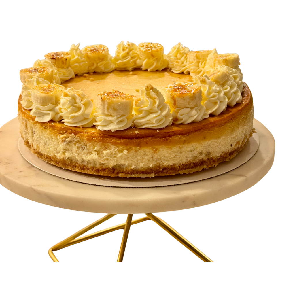 Whole banana cheesecake ringed with piped cream and caramelized banana slices