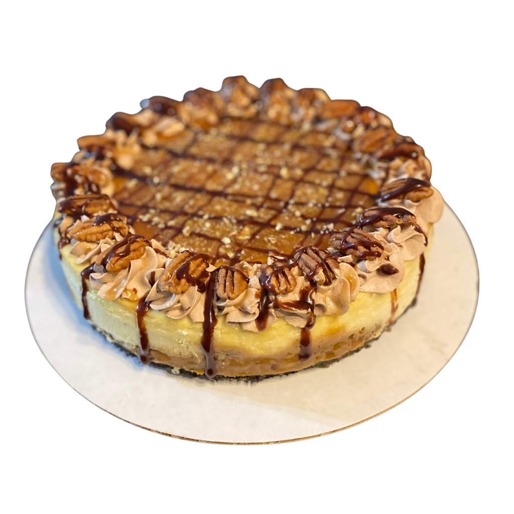 Whole cheesecake with caramel and chocolate drizzle, mocha rosettes and toasted pecans