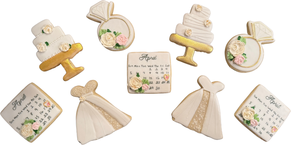 Wedding cookies shaped like tiered cakes, rings, gowns and a calendar page
