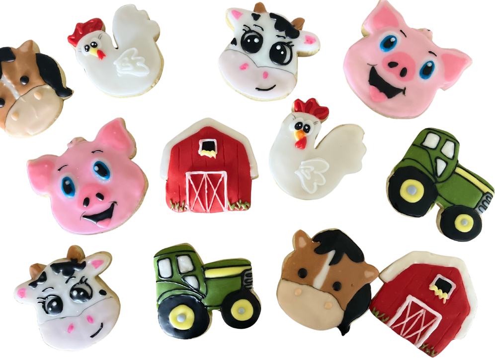 Farm cookies shaped like cows, pigs, chickens, a red barn and a green tractor