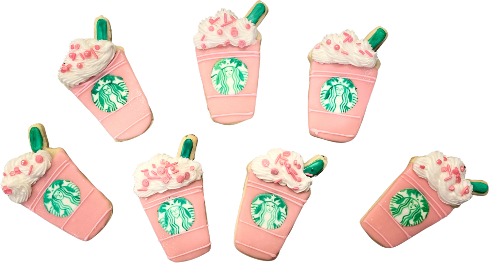 Cookies shaped like pink iced coffee cups topped with whipped cream and sprinkles
