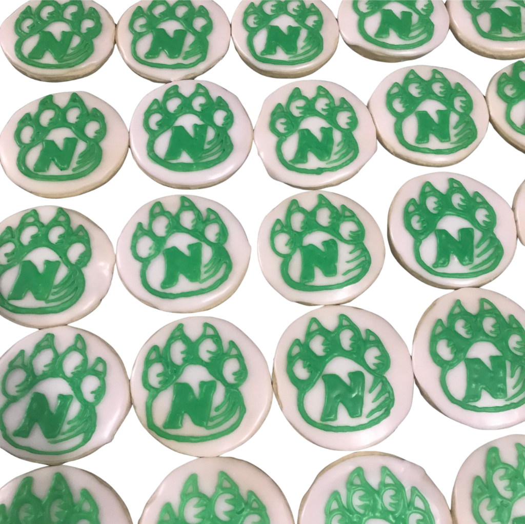 Rows of round cookies with the green Northwest Missouri State Bearcat paw